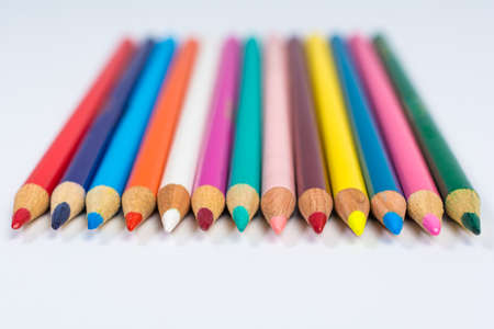 Line of Colored Pencil Crayons Isolated on White Front Viewの写真素材