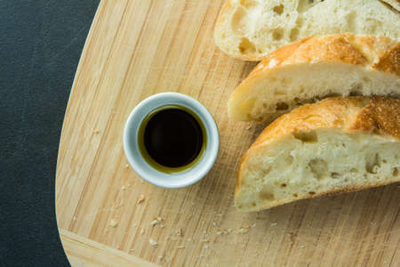 Sliced bread on cutting board with oil top viewの写真素材