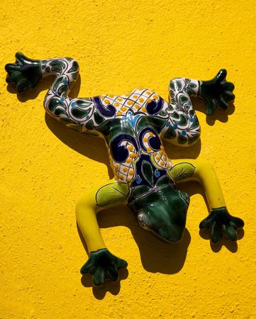 Mexican Ceramic Frog, Yellow Wall, Guanajuato, Mexico.  Guanajuato is known as the Frogs Place for the mountains around the city that look like frogs.Resubmit-In response to comments from reviewer have further processed image to reduce noise and sharpenの写真素材