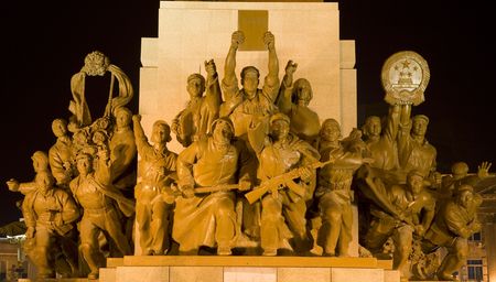 Mao Statue Heroes at the Base of Statue Zhongshan Square Shenyang, Liaoning province, China at Night.  Built in 1969 during the Cultural Revolution.  One hero is holding up copy of a book on the thoughts of Mao Zedong.の写真素材