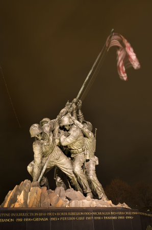 The Marine Corps War Memorial Shows the Raising of the Flag at Iwo Jima in World War II  Washington DC Statue finished in 1954  Plane Trail in Backgroundのeditorial素材