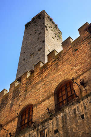 Medieval Stone Tower Town Hall San Gimignano Tuscany Italy Pink Flowers Windows Wallsの写真素材