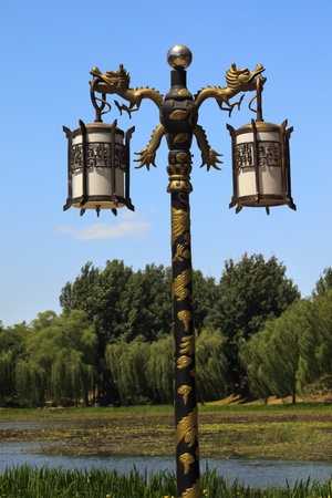 Ornate Golden Dragon Lamp Post Yuanming Yuan Old Summer Palace Willows Beijing Chinaの写真素材