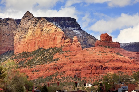 Ship Rock  Butte Orange Red Canyon Houses Shopping Area, Red Lights, Blue Cloudy Sky Green Trees Sedona Arizonaの写真素材