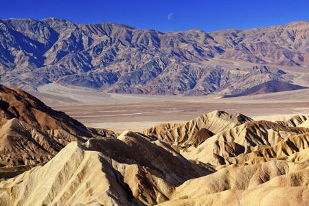 Moon Over Zabriski Point Mudstones form Badlands  Death Valley National Park Californiaの写真素材