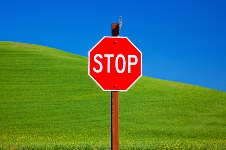 Red Stop Sign Green Wheat Grass Fields Blue Skies Abstract Palouse Washington State Pacific Northwestの写真素材