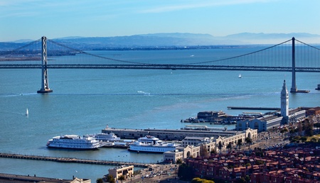 Bay Bridge and Ferry Terminal Boats and Apartment Buildings from Coit Tower San Francisco California on Telegraph Hill   の写真素材