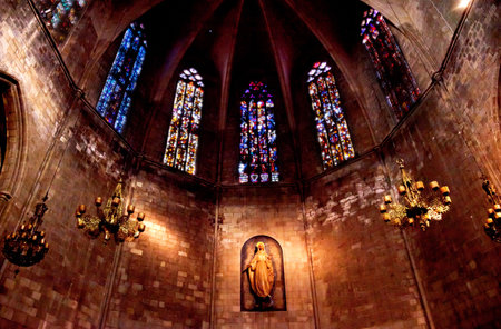 Stained Windows and Mary Statue in Old Stone Basilica, St Maria del Pi, Saint Mary of Pine Tree, in Barcelona, Spain  Saint Maria del Pi was founded in 987AD or earlier  One of the oldest churches in Barcelona のeditorial素材