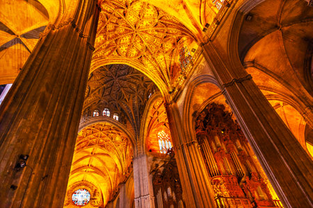 Stone Columns Stained Glass Seville Cathedral, Cathedral of Saint Mary of the See, Seville, Andalusia Spain   Built in the 1500s   Largest Gothic Cathedral in the World and Third Largest Church in the World   Burial Place of Christopher Columbus のeditorial素材