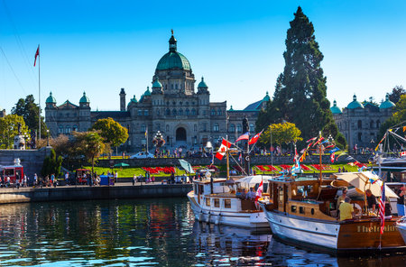 Provincial Capital Legislative Parliament Buildiing and Wooden Boats in Inner Harbor British Columbia Canada on August 31, 2013のeditorial素材