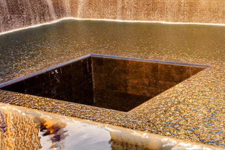 911 Memorial Pool Fountain Waterfall Reflections Abstract New York NY.  Pool is in the foundation of one of the Two World Trade Center Buildings.  Water falls into hole of the foundation.  のeditorial素材