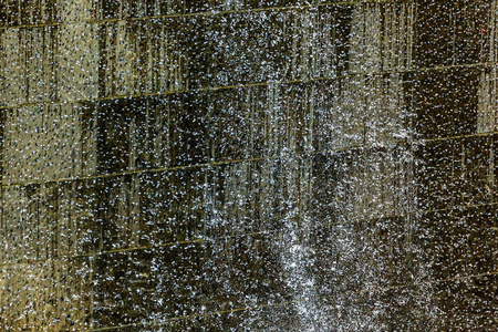 911 Memorial Pool Blue Waterfall Droplets Patterns Abstract New York NY.  Pool is in the foundation of one of the Two World Trade Center Buildings.  Water falls into hole of the foundation.の写真素材