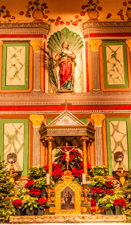Old Mission Santa Ines Basilica Altar Cross Agnes Statue Solvang California at Christmas.  Founded in 1804, 19 of 21 Missions in California.  Named for Saint Agnes, young Roman girl martyr, symbol of purity and chastity.のeditorial素材