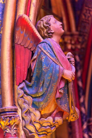 Angel Wood Carving Cathedral Saint Chapelle Paris France.  Saint King Louis 9th created Sainte Chappel in 1248 to house Christian relics including Christ's Crown of Thorns.  Stained Glass created in the 13th Century and shows various biblical stories alonのeditorial素材