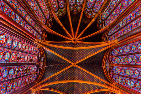 Stained Glass Cathedral Ceiling Saint Chapelle Paris France.  Saint King Louis 9th created Sainte Chappel in 1248 to house Christian relics including Christ's Crown of Thorns.  Stained Glass created in the 13th Century and shows various biblical stories aのeditorial素材