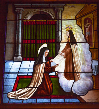Saint Teresa Communicating Angel Stained Glass Convento de Santa Teresa Basilica Avila Castile Spain.  Convent founded in 1636 for Saint Teresa, Catholic nun, Counterreformation author, and Spanish mystic, who founded the Carmelite order. Died in 1582 andのeditorial素材