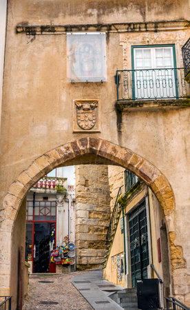 Old 12th Century Arch Arco de  Almediina Medieval City Coimbra Portugal. Arch leads to Upper Town and University in Coimbraのeditorial素材