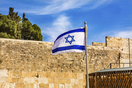 Israeli Flag Western"Wailing" Wall of Ancient Temple Jerusalem Israel.  Western wall of the Ancient Jewish Temple built in 100BC by Herod the Great on the Temple Mount.  Judaisim's most holy siteの写真素材