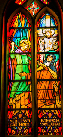 Saint Teresa Avila Angel Spear Christ Stained Glass De Krijtberg Church Amsterdam Holland Netherlands. Stained Glass in De Krijtberg, Catholic Church, in Amsterdam.  Saint Teresa was a Catholic nun, Counterreformation author, and Spanish mystic, who foundのeditorial素材