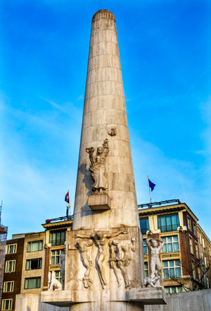 National World War II Monument Dam Square Amsterdam Holland Netherlands. Built in 1956, Sculptor Paul Gregoire.  Four Chained men representing suffering in World War II, Christ like figure in center.のeditorial素材