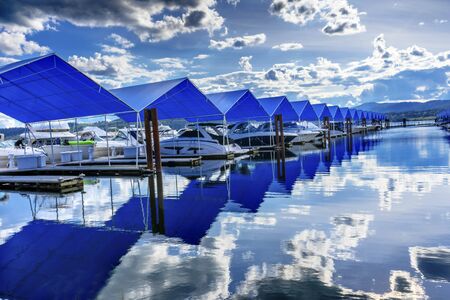 Blue Covers Boardwalk Marina Piers Boats Reflection Lake Coeur d' Alene Idahoの写真素材