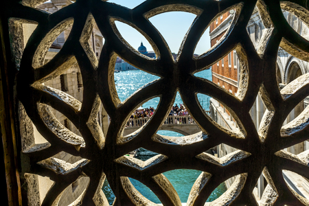 Tourists Bridge Colorful Small Canal Bridge of Sighs Buildings Venice Italy.  Bridge between Doge's Palace and Prison.  Called Bridge of Sighs because last sight person sees before torture prison and deathの写真素材