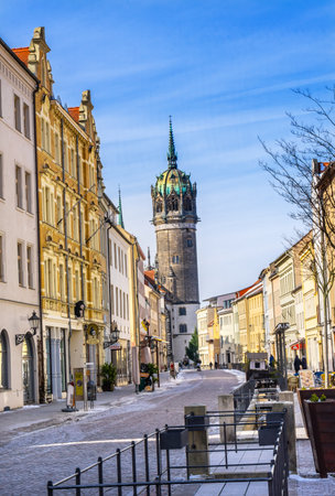 Snow Covered Street Shops Restaurants All Saints Castle Castle Church Schlosskirche Lutherstadt Wittenberg Germany. Where Luther posted 95 thesis 1517 starting Protestant Reformation.のeditorial素材
