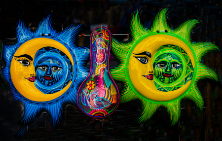 Colorful Mexican Ceramic Sun Moon Face Handicraft Blue Turquoise Yellow Green Oaxaca Juarez Mexico.の写真素材