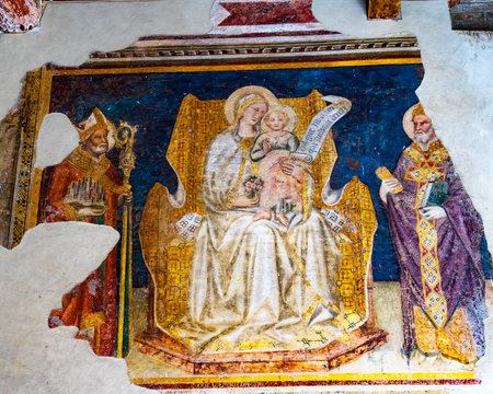 Madonna and Child Between Saints Gregory and Gimignano Fresco by Taddeo di Bartolo Outside San Gimignano Italy Fresco from early 1500s.のeditorial素材