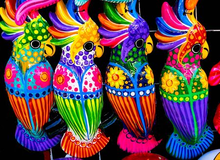 Colorful Blue Pink Yellow Ceramic Parrots Oaxaca Mexico.  Many ceramic factories throughout the countryの写真素材