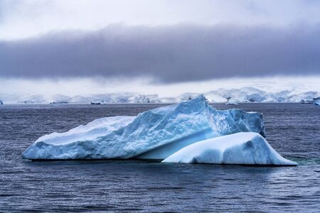 Blue Iceberg Glaciers Charlotte Bay Antarctic Peninsula Antarctica.  Glacier ice blue because air squeezed out of snow.の写真素材