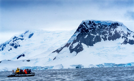 Ship Tourists Rubber Boats Zodiac Glaciers Snow Mountans Charlotte Bay Antarctic Peninsula Antarctica.  Glacier ice blue because air squeezed out of snow.のeditorial素材