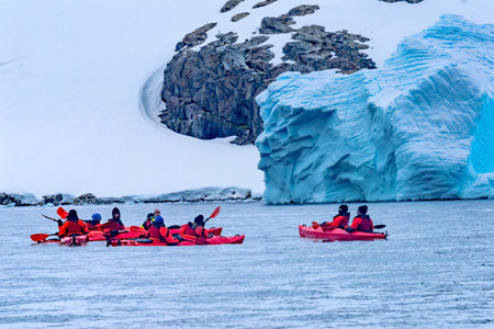 Red Kayaks Tourists Glaciers Snow Mountans Charlotte Bay Antarctic Peninsula Antarctica.  Glacier ice blue because air squeezed out of snow.のeditorial素材