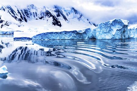 Snow Mountains Abstract Reflection Blue Glaciers Iceberg Dorian Bay Antarctic Peninsula Antarctica.  Glacier ice blue because air squeezed out of snow.の写真素材