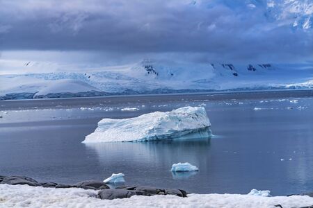 Iceberg Snow Mountains Blue Glaciers Damoy Point Antarctic Peninsula Antarctica.  Glacier ice blue because air squeezed out of snow.の写真素材