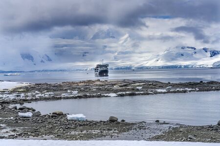 Cruise Ship Snow Mountains Blue Glaciers Damoy Point Antarctic Peninsula Antarctica.  Glacier ice blue because air squeezed out of snow.の写真素材
