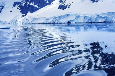 Snow Mountains Abstract Reflection Blue Glaciers Iceberg Dorian Bay Antarctic Peninsula Antarctica.  Glacier ice blue because air squeezed out of snow.の写真素材
