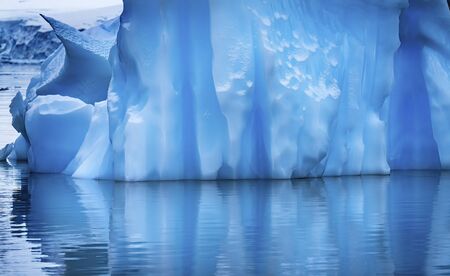 Floating Blue Iceberg Reflection Paradise Bay Skintorp Cove Antarctica. Glacier ice blue because air...