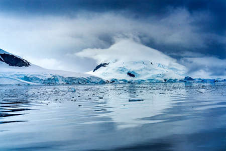 Blue Glacier Snow Mountains Paradise Bay Skintorp Cove Antarctica. Glacier ice blue because air...