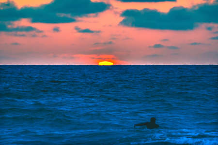 Surfer Paddling Out Sunset La Jolla Shores Beach San Diego Californiaの写真素材