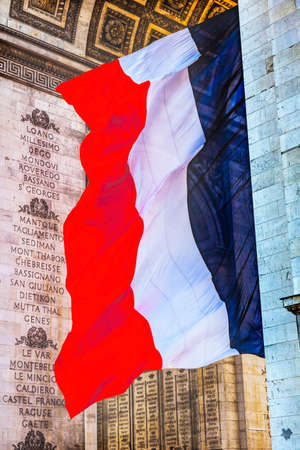 Arc de Triomphe French Flag Paris France. Completed in 1836 monument to the dead in the French Revolution and Napoleonic Wars. Includes tomb to unknown soldierの写真素材