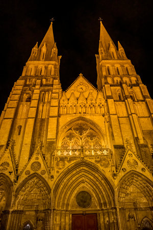 Night Outside Illuminated Lights  Bayeux Cathedral Facade Towers Our Lady of Bayeux Church Bayeux Normandy France. Catholic church consecrated by King William the Conquerer in 1077のeditorial素材