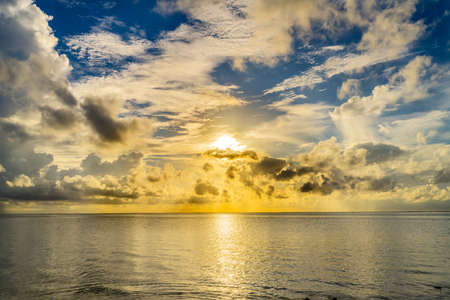 Sunset Reflection Cloudscape Outer Reef Blue Water Moorea Tahiti French Polynesia. Different blue colors in water in  lagoon and coral reefsの写真素材