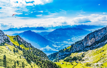 Mountains Pink Parasail Rocky Cliffs Pastures Trees Climbing Mount Pilatus Lucerne Switzerland climbing to Mt. Pilatus observation pointの写真素材