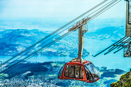 Colorful Cable Car Descending Mount Pilatus Lake Lucerne Distance Lucerne Switzerland. Descending from Mt. Pilatus observation pointの写真素材