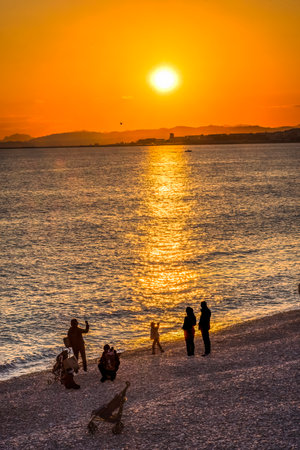 People Watching Sun Go Down Beach Reflection Airport Mediterranean Sea Coastline Seacoast Nice Cote d'Azur Franceの写真素材