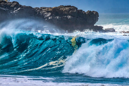 Large Waves Rock Surf Board Waimea Bay North Shore Oahu Hawaii. Waimea Bay is famous for big wave surfing. On this day, waves were 15 to 20 feet high.の写真素材