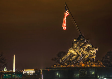 The Marine Corps War Memorial Shows the Raising of the Flag at Iwo Jima in World War II  Washington DC  Statue finished in 1954.  Lincoln Memorial, Washington Monument and US Capitol in the background.の写真素材