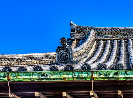 Colorful Roof Crests Nijo Castle Kyoto Japan. Completed in 1626 by Tokugawa Shoguns. In 1867 Castle returned to Emperor. Crest symbol of Imperial Court and Three Leaf Crest of Tokugawa Shogunate.の写真素材