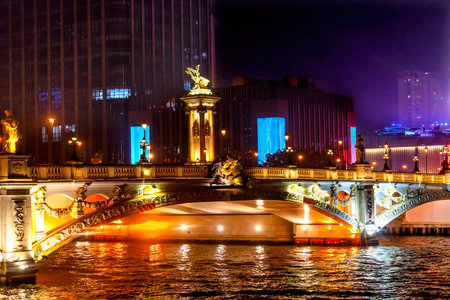 Colorful Beian Bridge Large Office Buildings Night Illuminated Hai River Tianjin China. Built in 1939. Mix of Chinese and European Culture with Chinese and French Statues.の写真素材